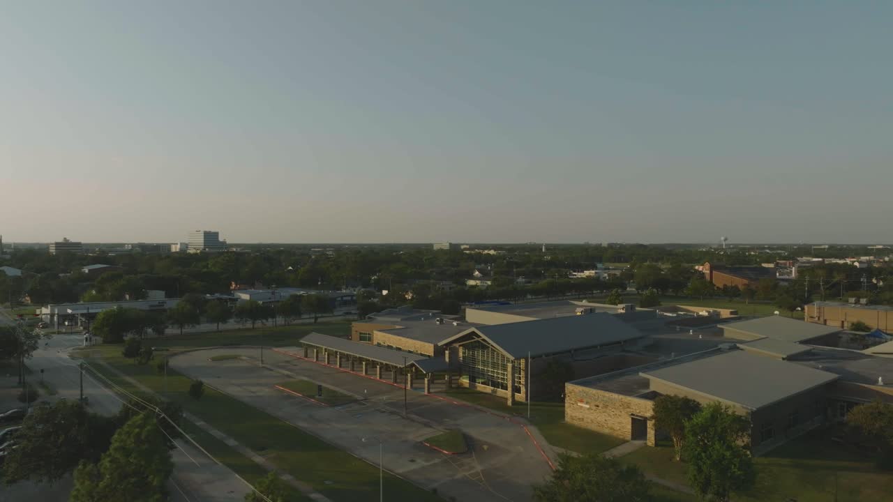 A half orbit aerial 4K drone view of Margaret S. McWhirter Elementary Professional Development Lab School at late evening in Webster, Texas.