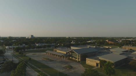 a half orbit aerial 4k drone view of margaret s. mcwhirter elementary professional development lab school at late evening in webster, texas.