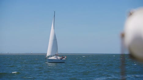 Un-Velero-Blanco-Navegando-En-Mar-Abierto-Con-Una-Bandera-Holandesa-En-Cámara-Lenta