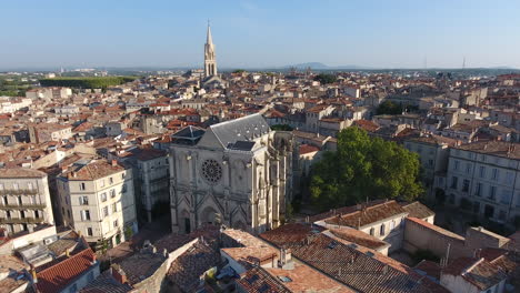 Aerial-flight-around-Saint-Roch-church-early-morning-in-Montpellier,-France.