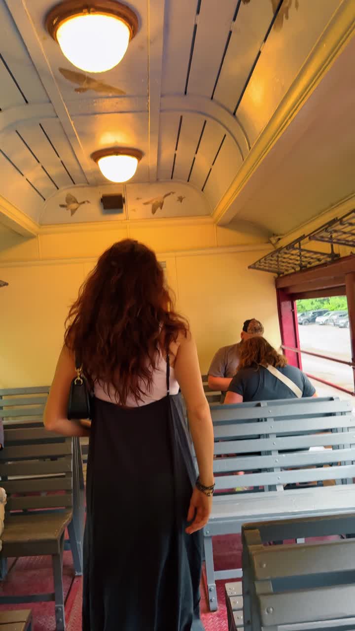 Boston, USA, 8 May 2025: Interior of vintage passenger train car with painted ceiling. Inside a classic railway carriage with wooden benches and blue ceiling depicting flying birds