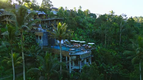 a drone view capturing a jungle-fringed bar with a stunning pool perched at its edge