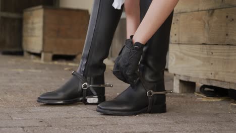 caucasian woman putting on her boots