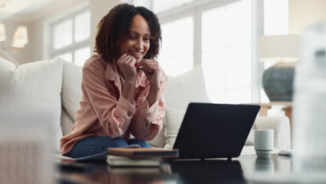 smiling woman working on laptop at home