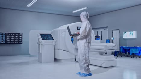 full body side view of asian male scientist typing on a laptop and looking around with mri machine in the hospital