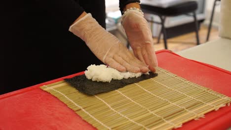 slowmo - japanese chef preparing sushi rolls