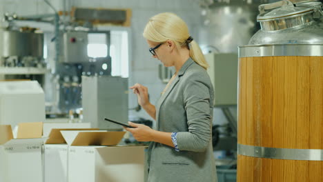 woman checks inventory with tablet