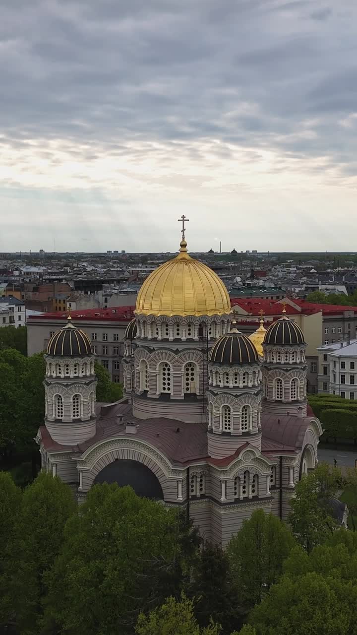 The Golden-domed Nativity of Christ Cathedral Rises Above the Trees in the Heart of Riga, Latvia - Vertical Shot