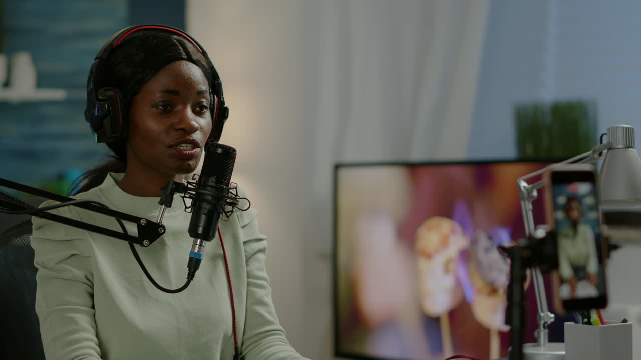 African vlogger recording video blog using smartphone