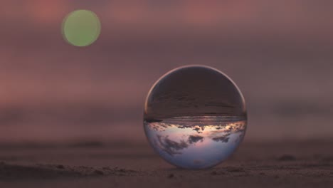 beautiful sunrise above the sea inside crystal ball.