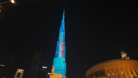 burj khalifa illuminated at night with music notes projection