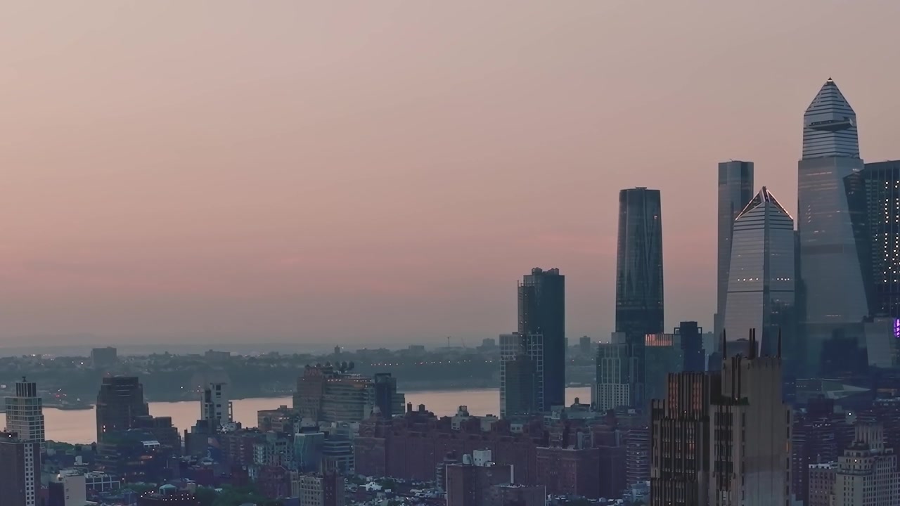 City skyline at dusk over the river in New York City, USA