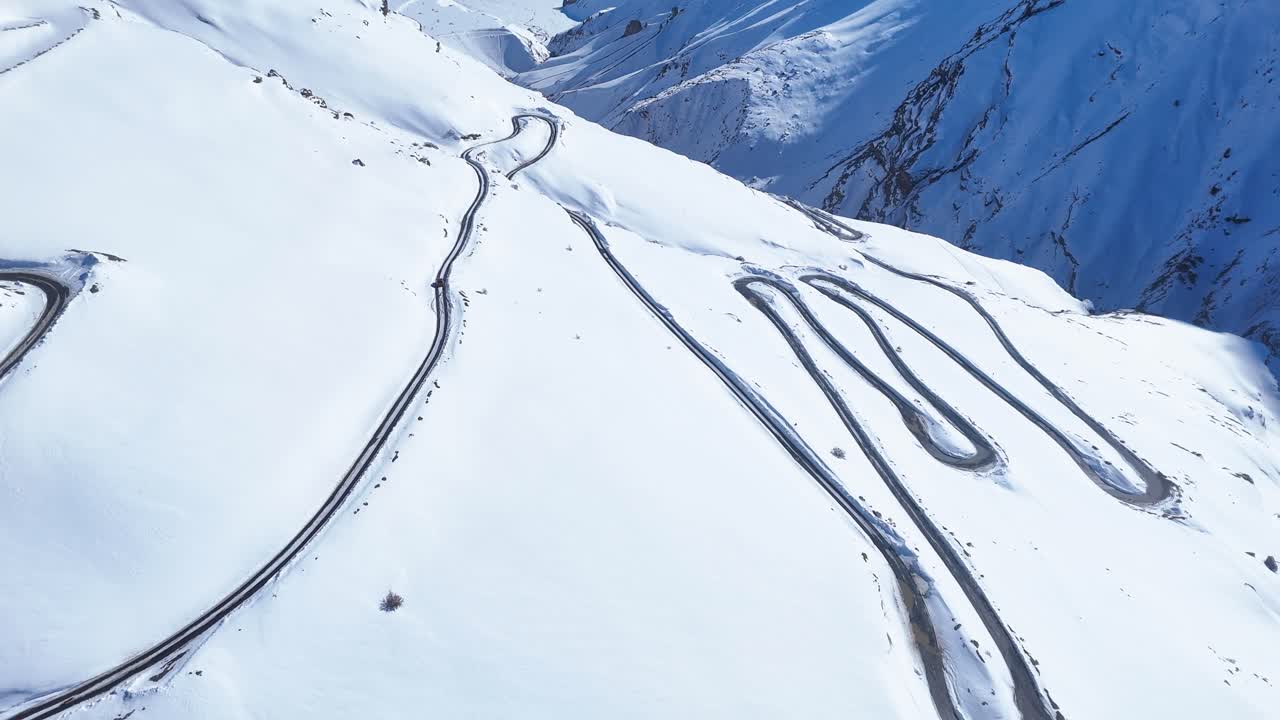 Snowy Mountain Road with Winding Curves