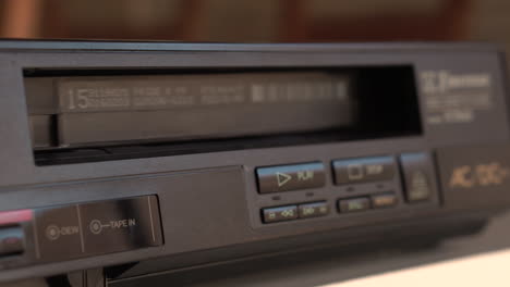 vcr player close up, pressing stop and eject vhs video tape