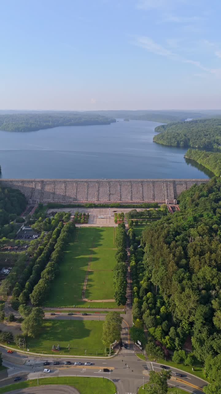 Majestic Kensico Dam Plaza, Reservoir at sunset, massive stone structure, blue water, and green park, Valhalla, New York. Aerial drone, vertical format, copy space