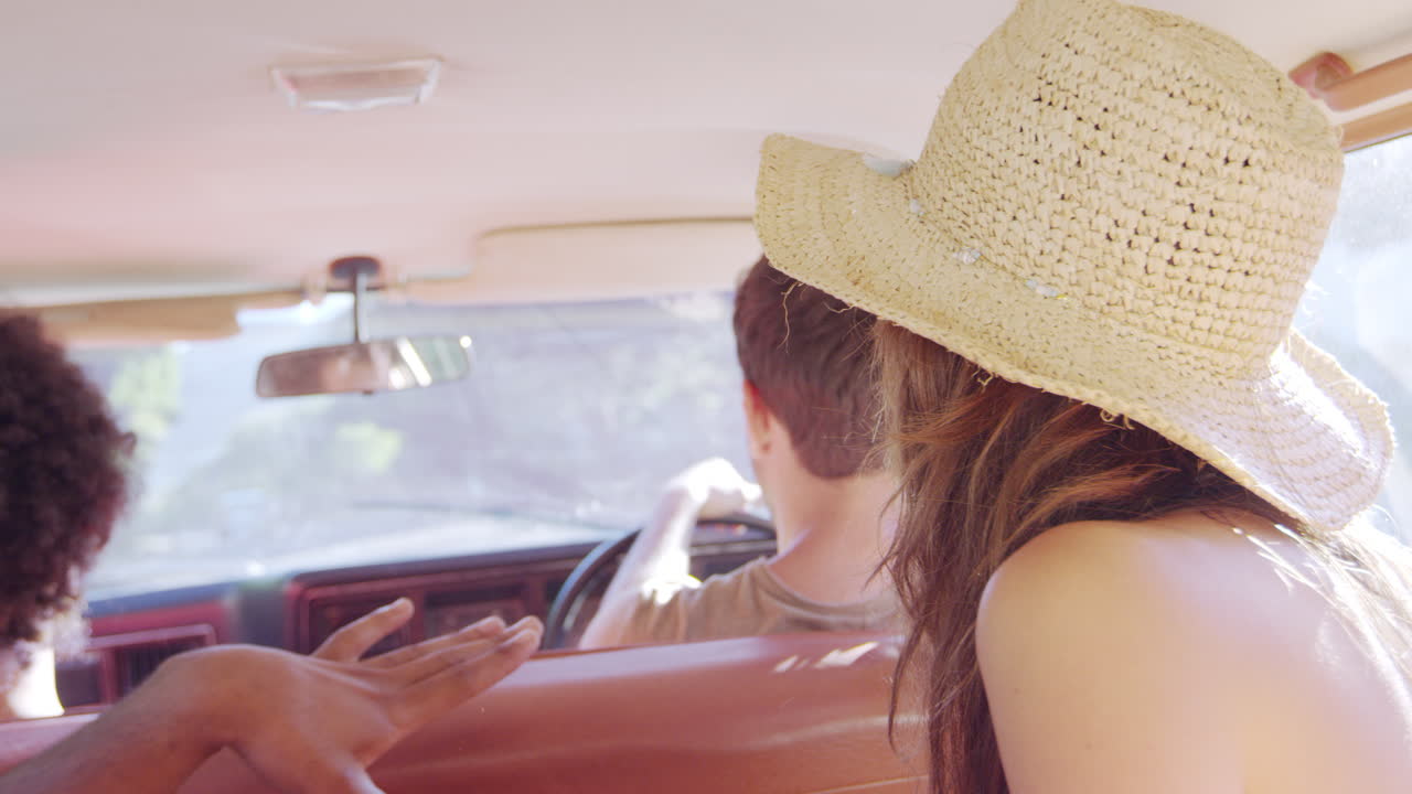 Group Of Friends Relaxing In Car During Road Trip