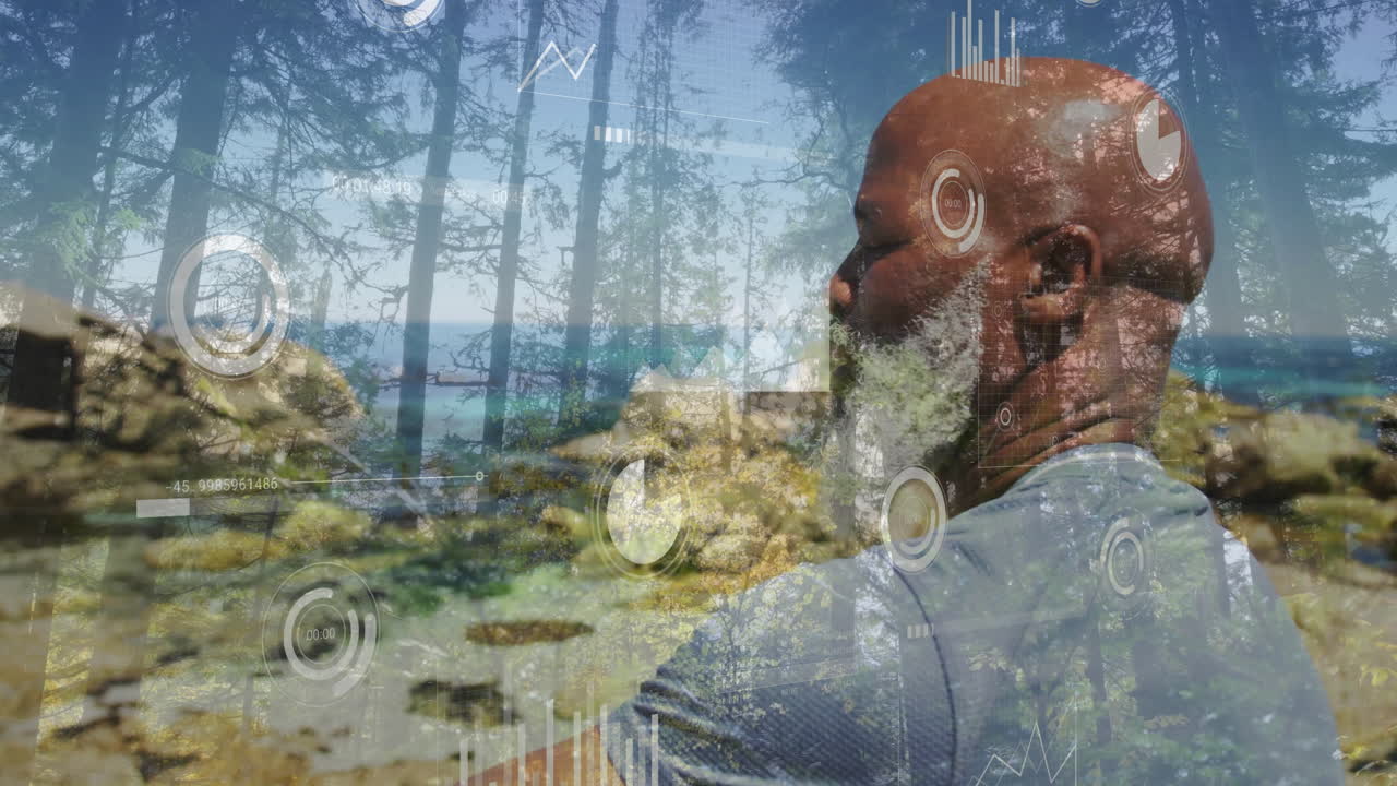 Viewing forest, elderly man with beard surrounded by digital animation graphics