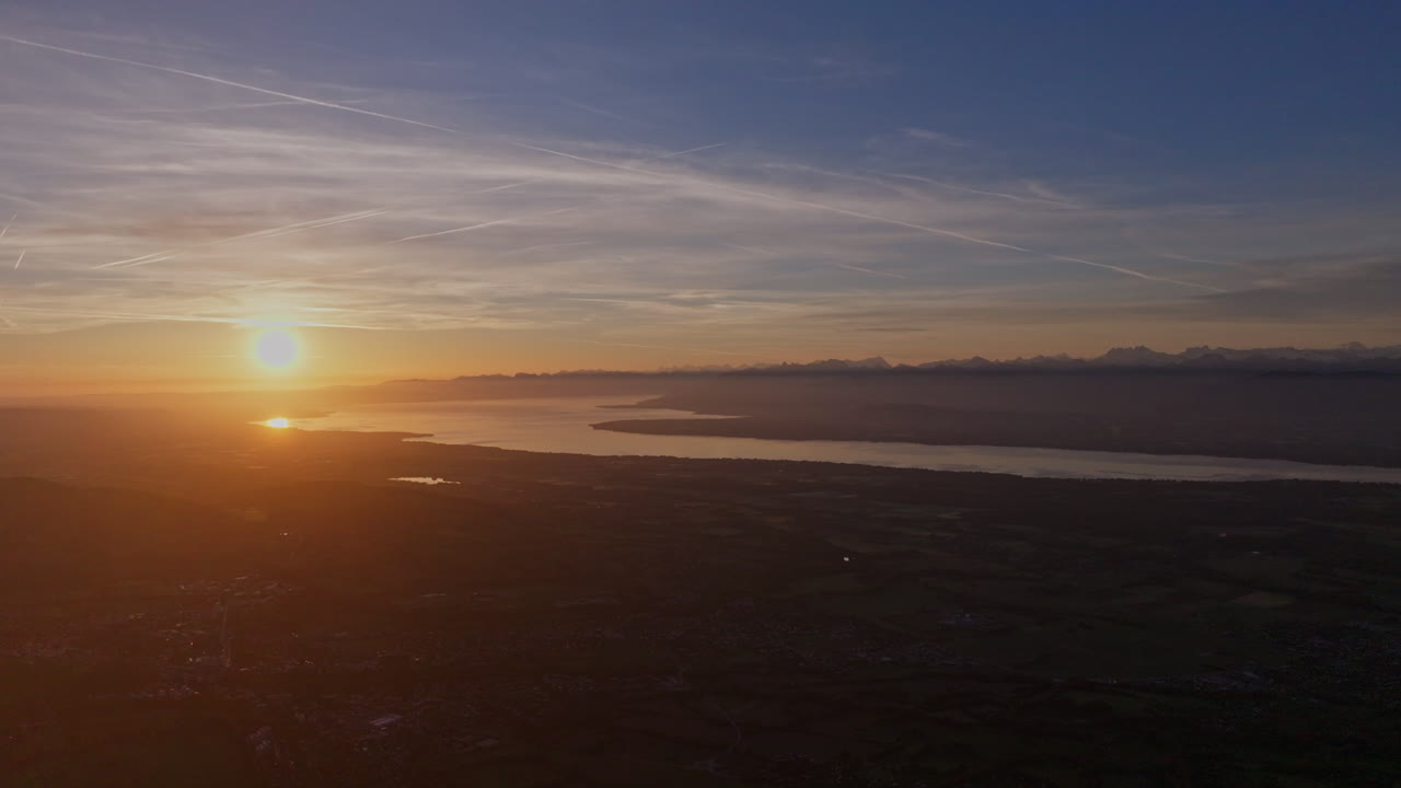 Peaceful morning in Geneva with the iconic Jet d’Eau rising from the lake, calm waters reflecting the clear sky, and the city slowly coming to life in the morning light.