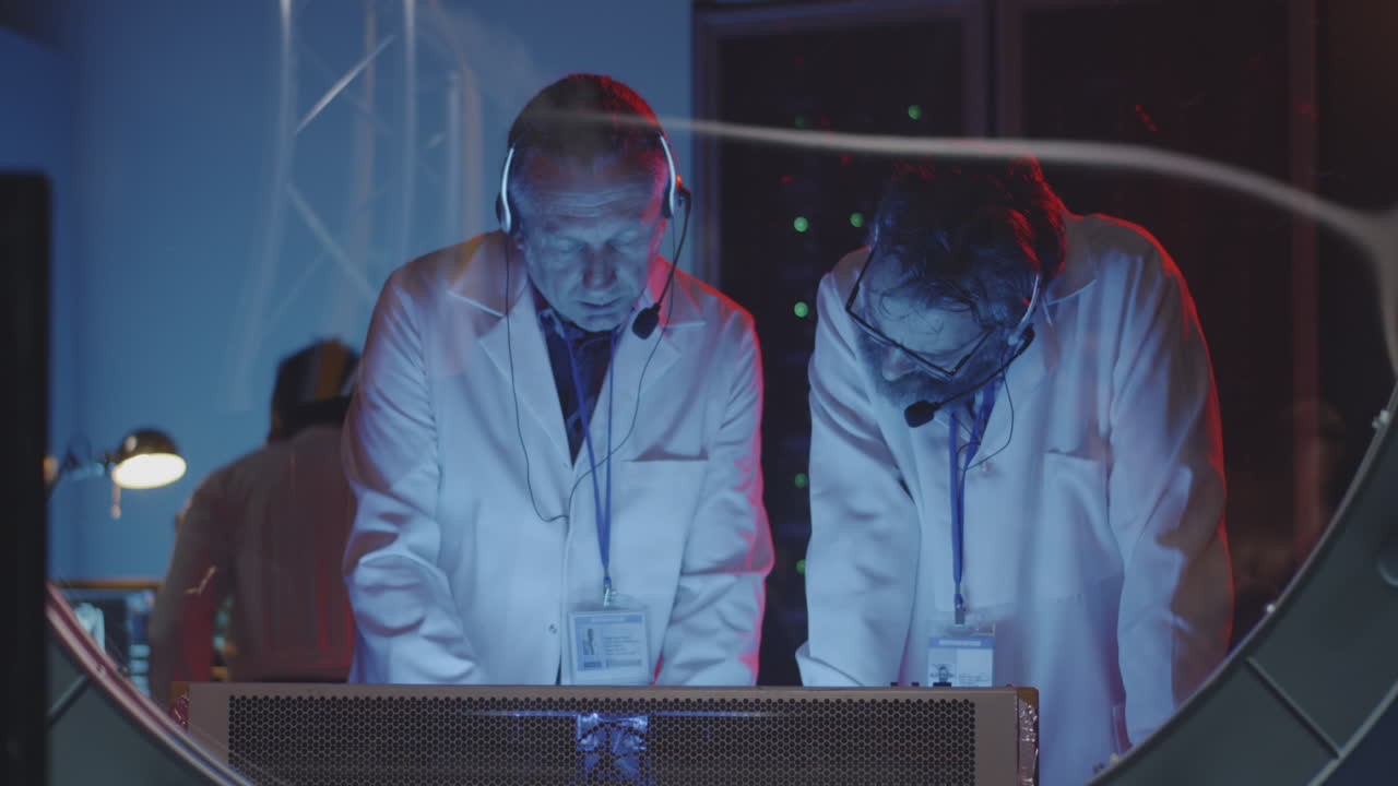 Scientists Monitoring Advanced Research Equipment