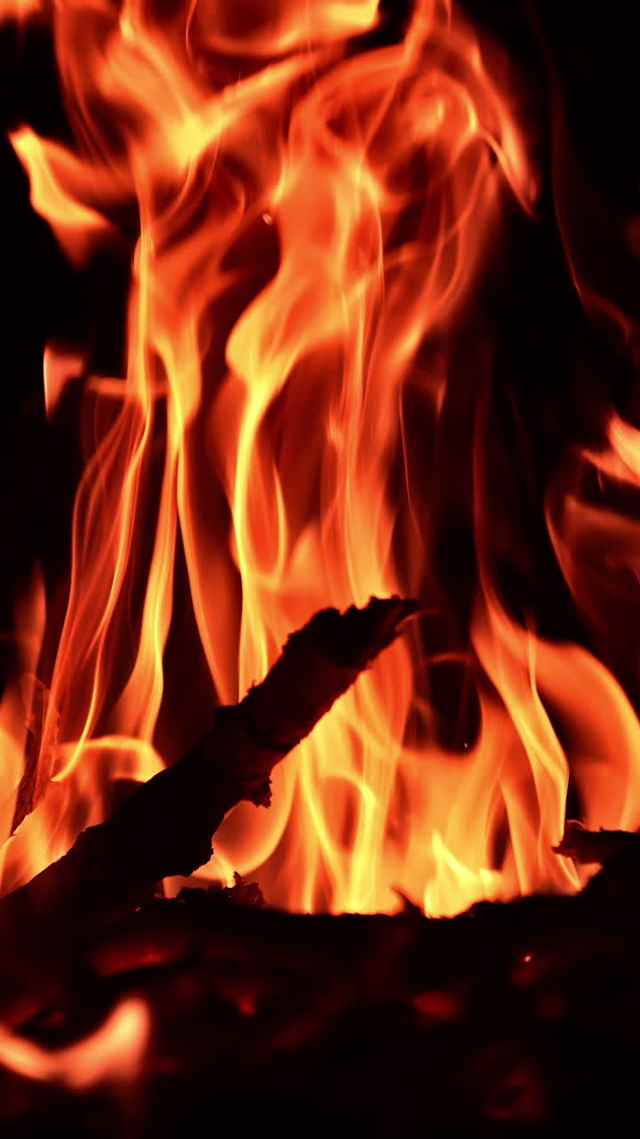 Night fireplace glowing. Bonfire flame heating in slow motion.