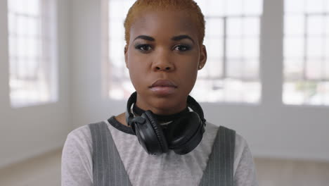 portrait-of-cool-trendy-african-american-woman-looking-serious-at-camera-in-empty-apartment-background-independent-lifestyle-change