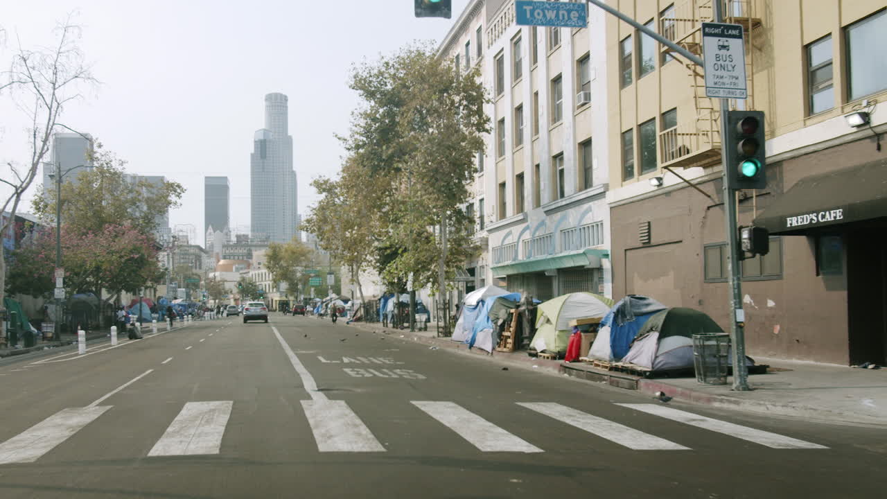 Homeless Encampment along a City Street with Downtown Los Angeles Skyline