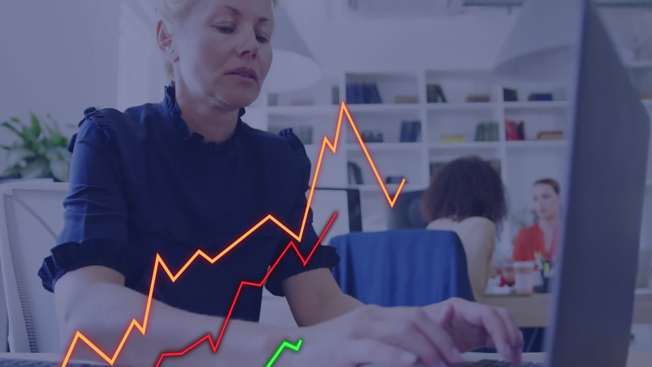 Animation of financial data processing over caucasian businesswoman using laptop in office