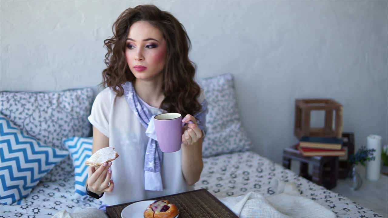 침대에서 아침 식사를 즐기는 여자