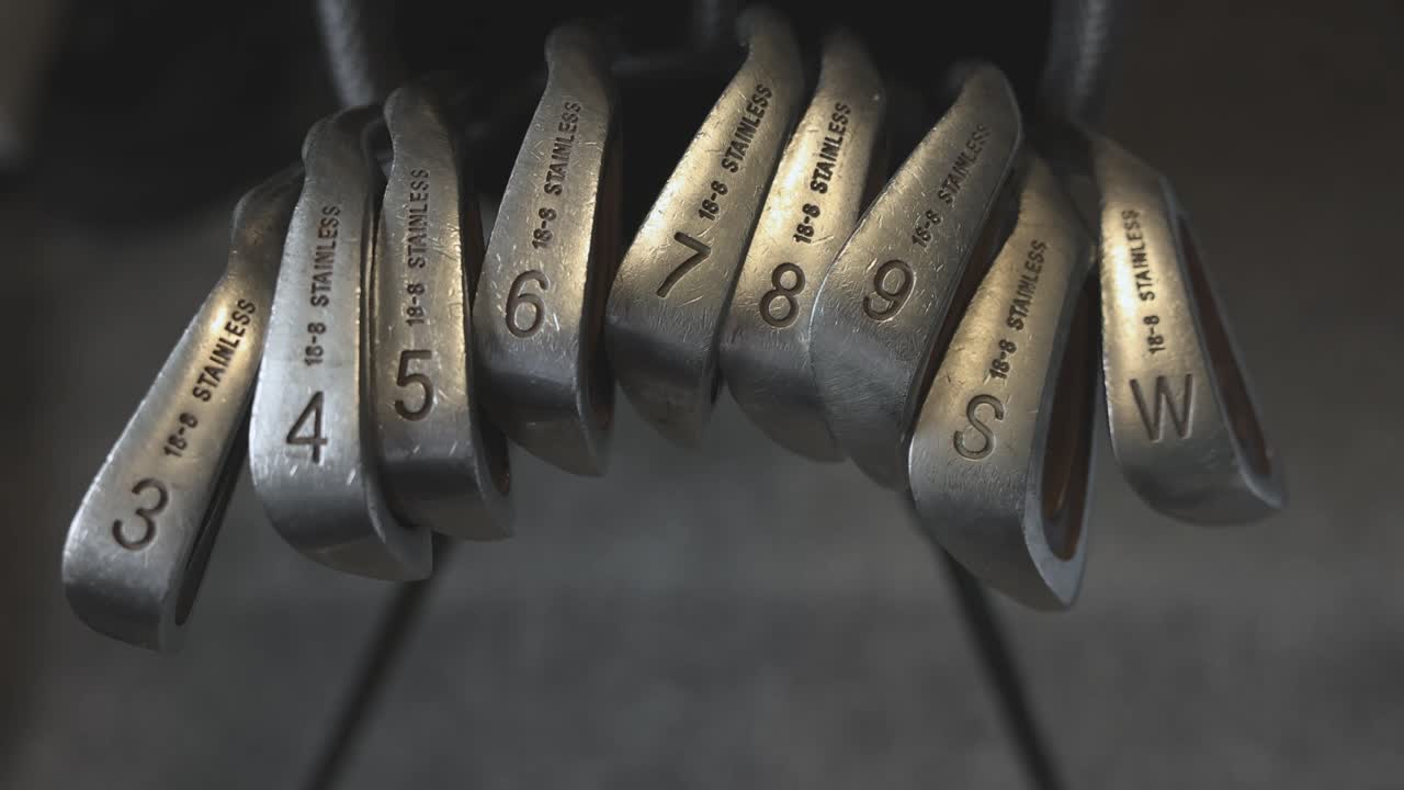 wide-angle shot of a full set of golf clubs standing within a golf bag