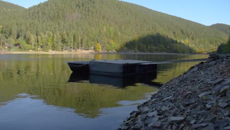 Idyllic-panoramic-view-of-a-big-lake-with-mountains-in-the-background-and-a-wooden-landing-stage-in-the-foreground-3