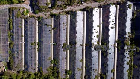 Flying-over-abandonned-greenhouses-and-farm,-in-Carros,-south-of-france,-next-to-a-house-with-swiming-pool