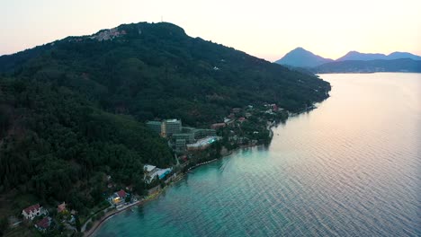 sunset on the greek coast. the sea, mountains and some buildings with a hotel can be seen