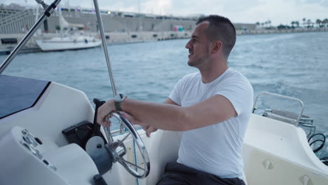 man driving a small boat on the water