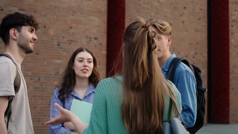 group of caucasian students standing at university campus and chatting