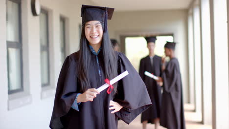 asian girl in graduation attire beams with pride, with copy space