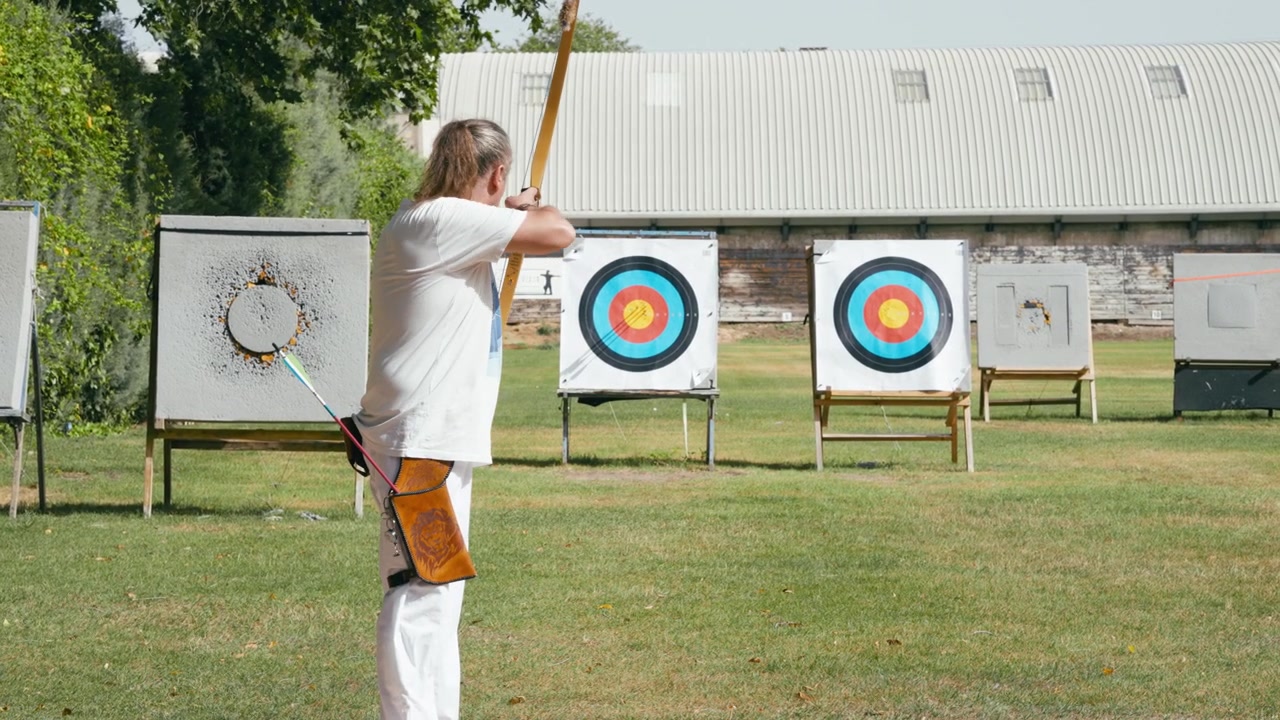 Archer Preparing and Aiming at Targets on Outdoor Range
