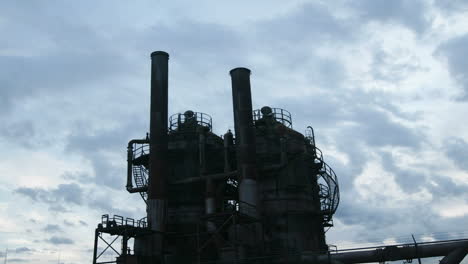 Clouds-move-across-the-sky-behind-an-oil-refinery