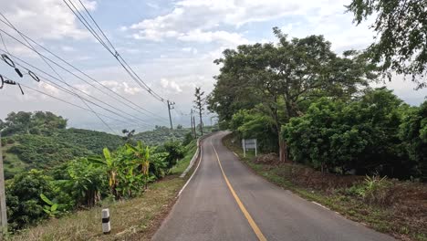 traveling along a winding road amidst lush greenery