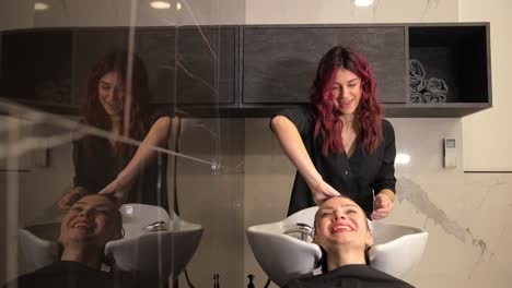 hairdressing salon, male client having hair washed at professional hairdressers