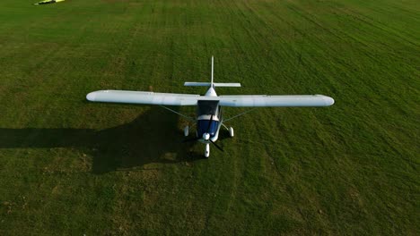 parked small single engine prop plane parked on grass lawn