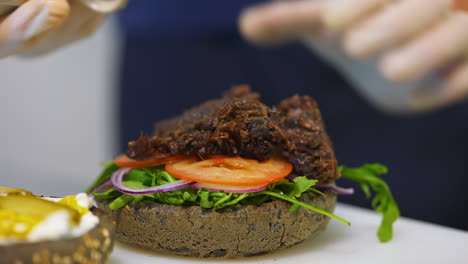 cooking fast food in restaurant. close up of chef cooking burgers in kitchen