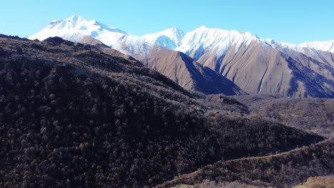 snow-capped mountain peaks, high caucasus mountains, shot from a drone