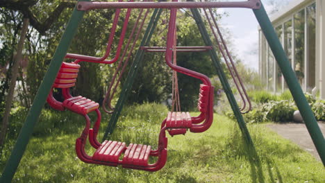 medium wide shot of a swingset on a sunny spring day