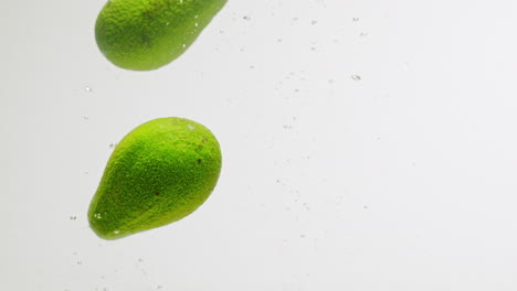 avocados splashing in water