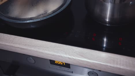 man turns off an induction cooker, end of cooking, cinematic shot, close up