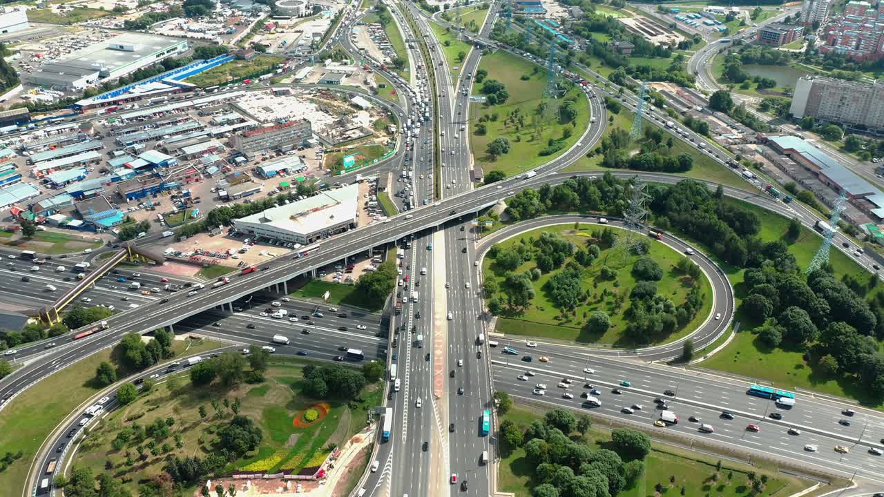 Aerial view of highway junction with traffic jam, urban scene