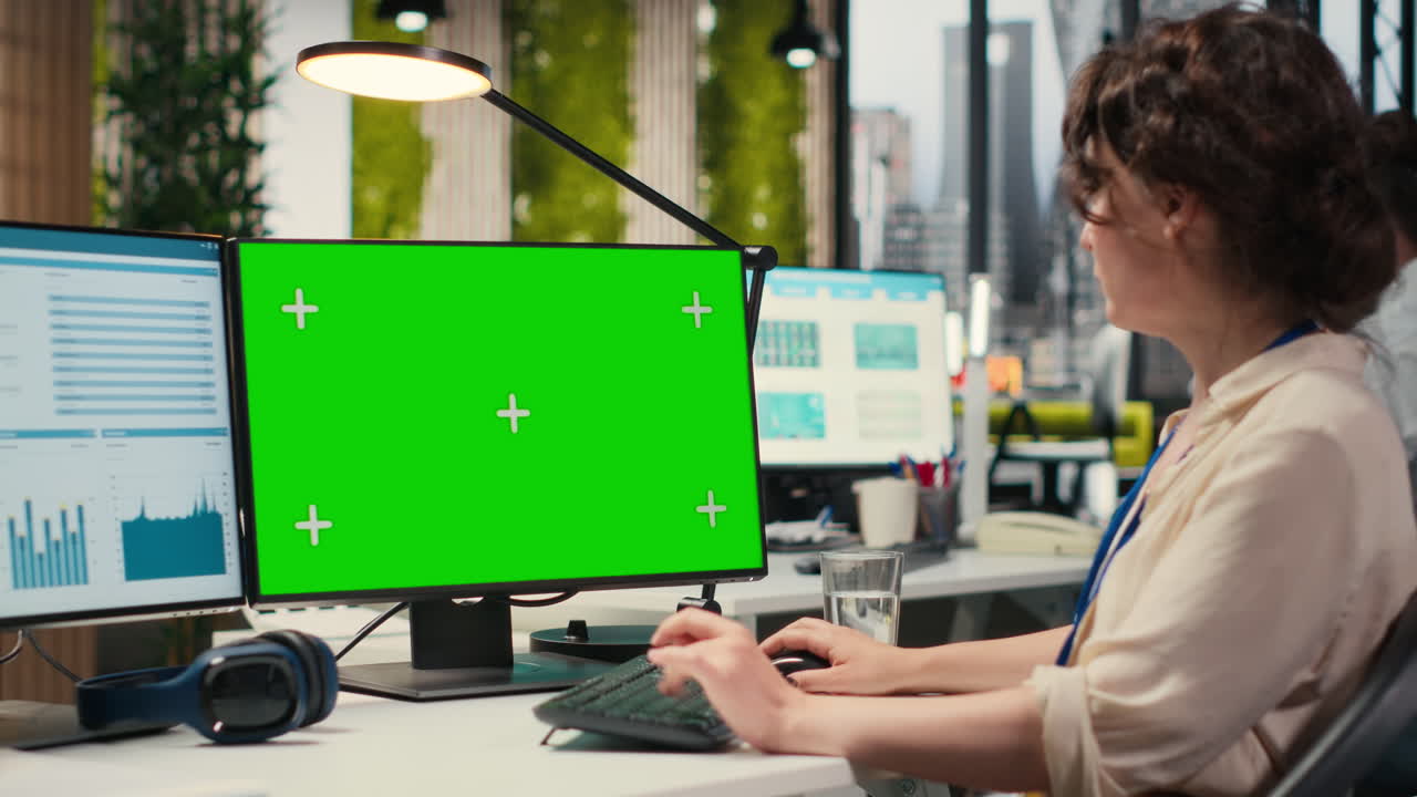 Woman business professional examines KPI data with chroma key screen