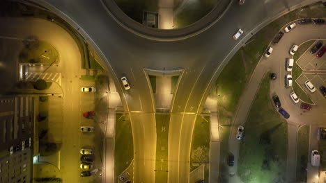 aerial night view of a busy highway interchange with cars moving