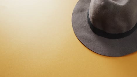 Video-of-close-up-of-hat-on-yellow-background