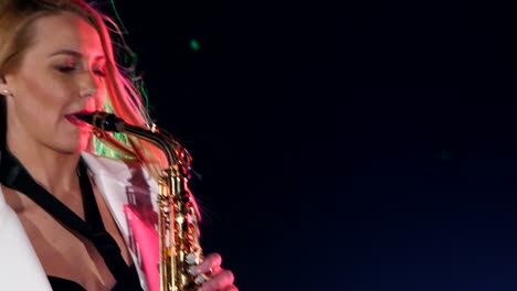 woman playing saxophone on stage